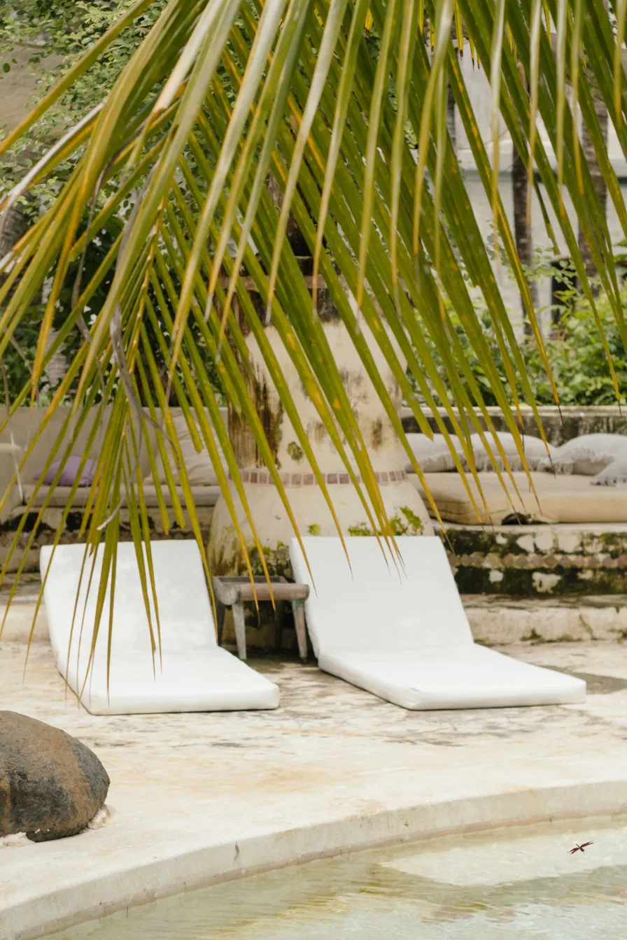 White lounge cushions by the pool